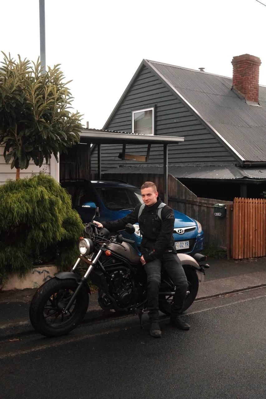 Young man by his motorcycle