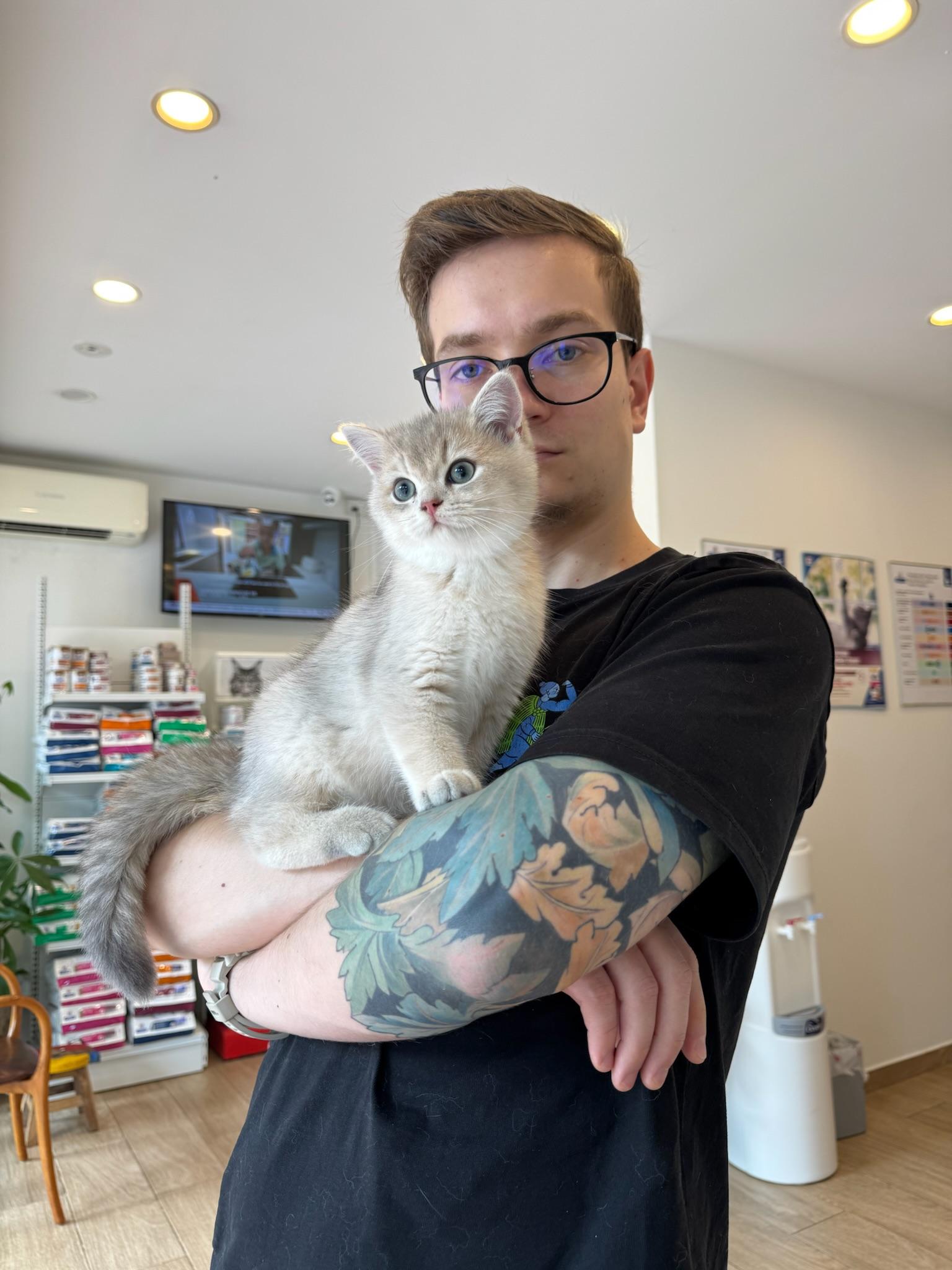 Young man holding a kitten